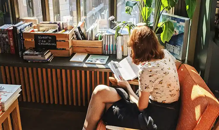 Girl sitting in book store reading