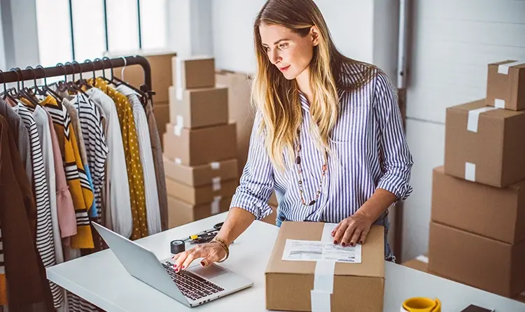 Small business owner packing orders in small office