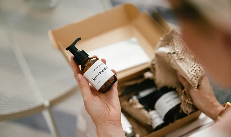 Woman unboxing a parcel and holding one of the products