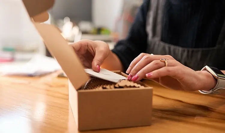 woman-hands-holding-a-gift-message-from-a-luxury-packag