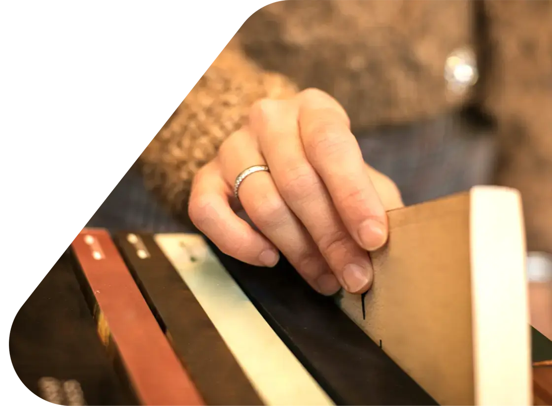 womans hand reaching for a book