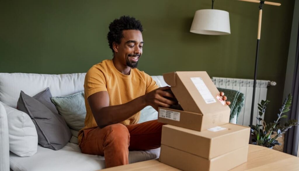 Smiling man opening a delivery box