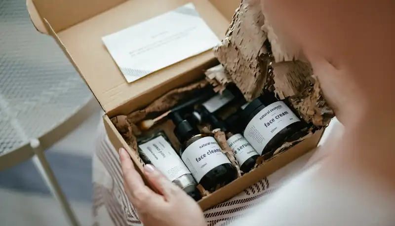 Person looking into a box of beauty products